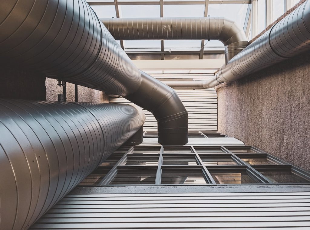 View of large HVAC ducts from below, focusing on ventilation system architecture.